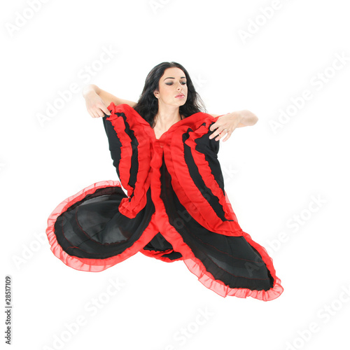 studio portrait of young beautiful woman dancing flamenco over w