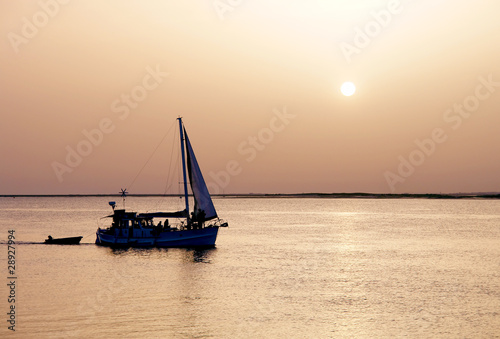 Recreation boat at sunset, in Ria Formosa, natural conservation