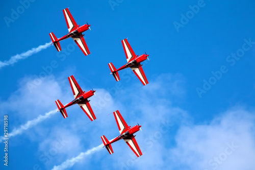 four airplanes in formation on airshow