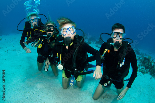 family scuba diving together