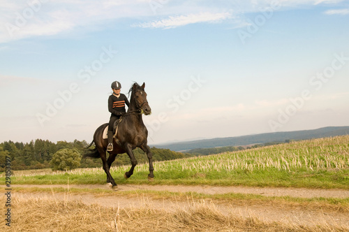 Rider rides at a gallop across the field.