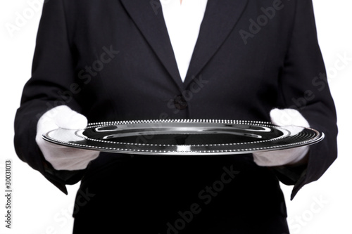 Female butler holding a silver tray isolated on white.