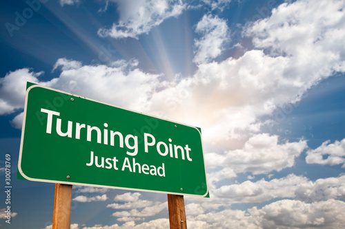 Turning Point Green Road Sign and Clouds