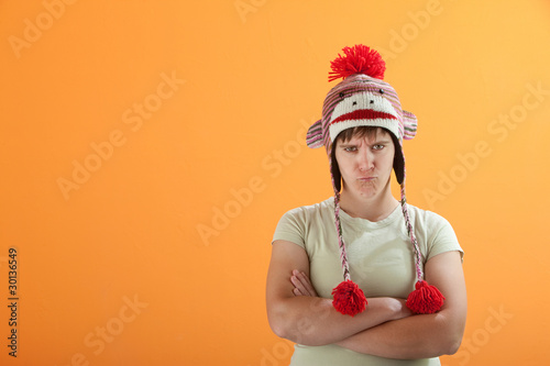 Upset young Caucasian woman in Monkey Cap