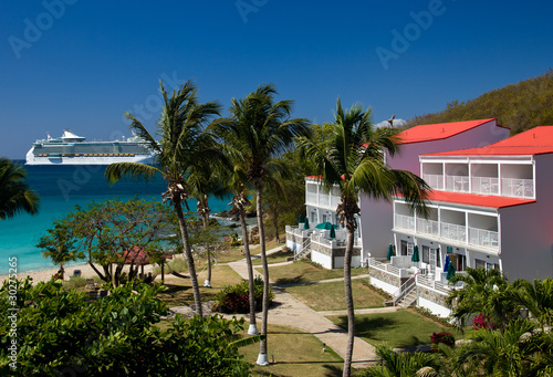 Cruise ship sails by vacation resort