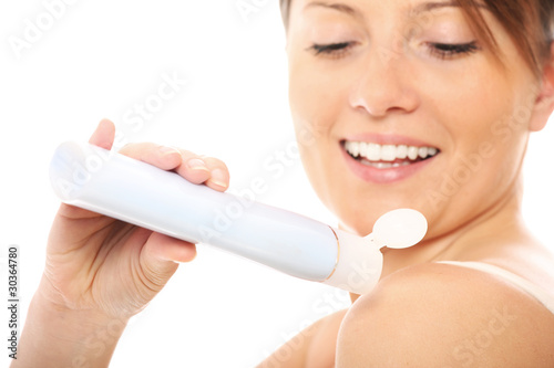 Woman using body lotion