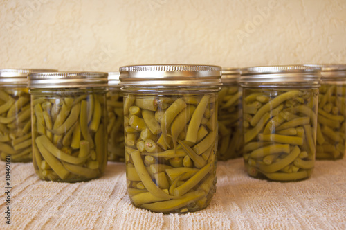 Home canned green beans cooling on the counter