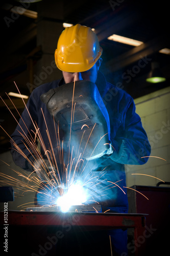 Worker making sparks while welding steel.