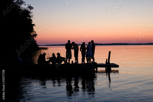 Silhouette of friends on dock