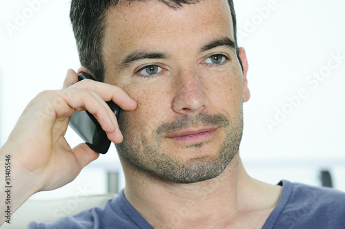 relaxed man is having a communication with a cellephone