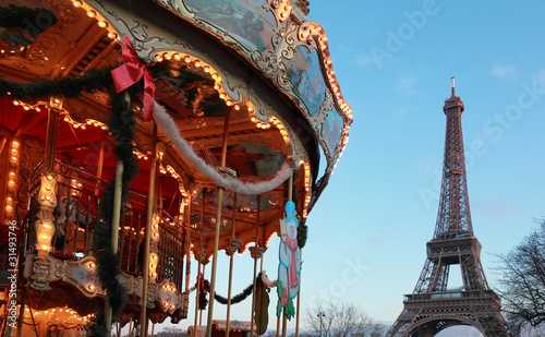 Vintage carousel with white horses near Eiffel tower