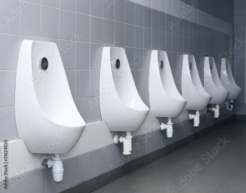 modern restroom interior with urinal row