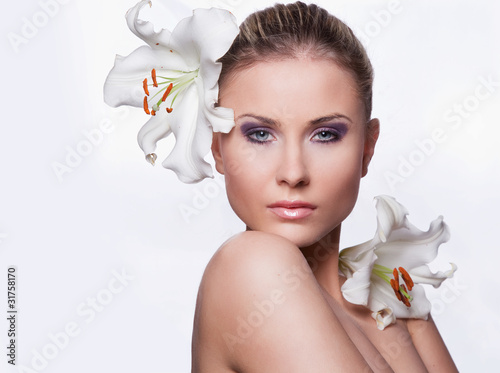 beautiful young woman with flowers on a white background
