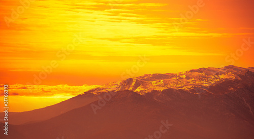 Very beautiful bright orange sunrise over mountains