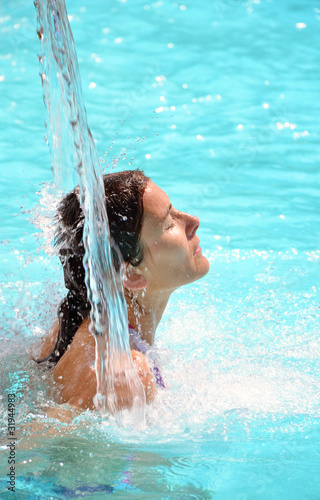 Jeune femme sous une cascade