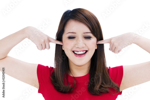 Happy young woman with fingers in her ears