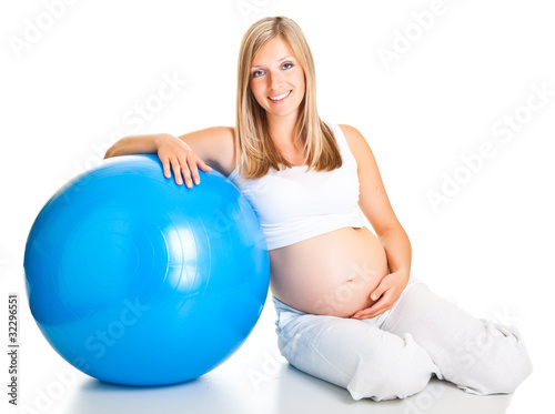 Pregnant woman excercises with gymnastic ball