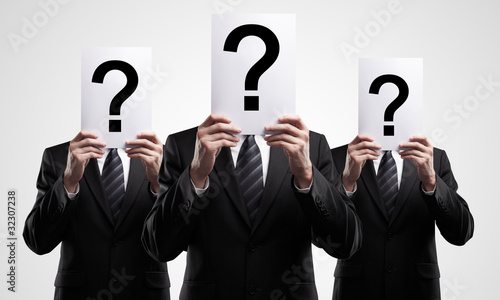 group of business people holding a question mark