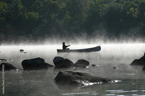 Fishing From a Canoe on a Misty Morning - Ontario, Canada