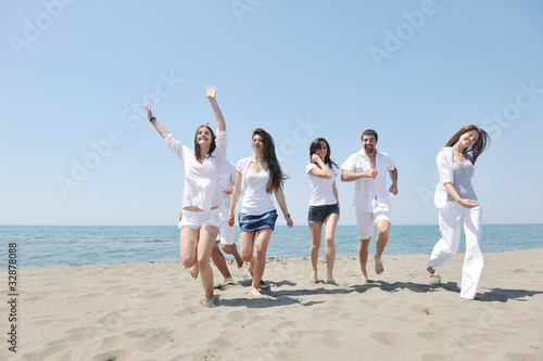 Group of happy young people in have fun at beach