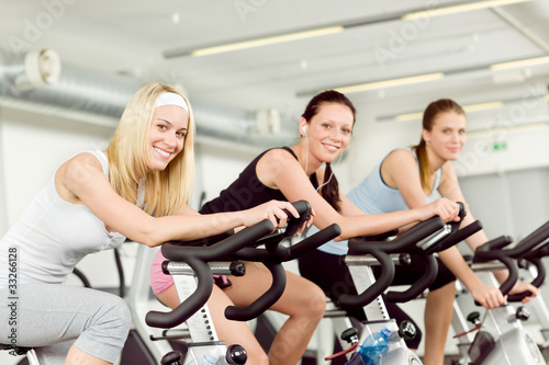 Fitness young woman on gym bike spinning