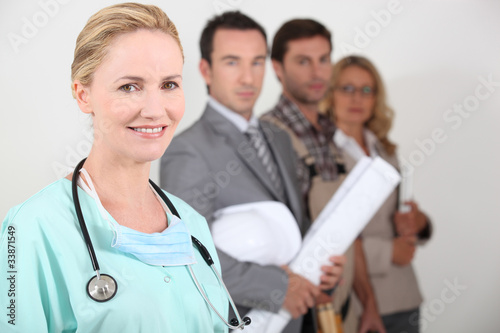 Female nurse stood next to four professionals from different