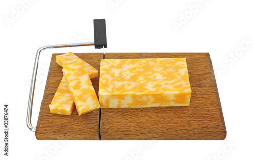 Sliced Colby Jack cheese on slicer