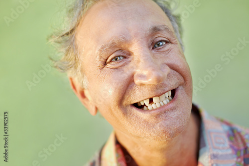 aged toothless man smiling at camera
