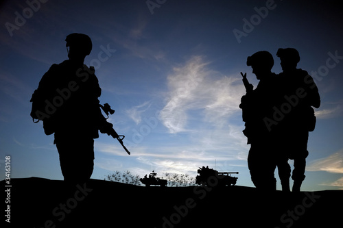 Silhouette of modern soldiers with military vehicles