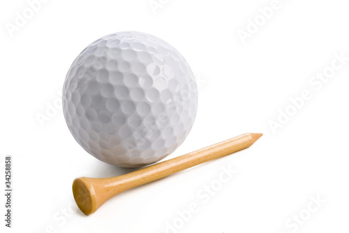 Golf ball with tee isolated on white