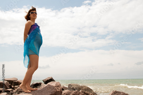 Young pregnant woman on sea coast