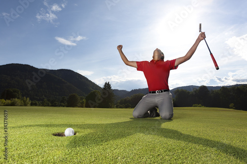 Happy golf player on geen.