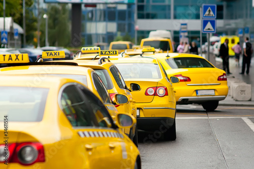 Yellow taxi cabs waiting in front of airport terminal