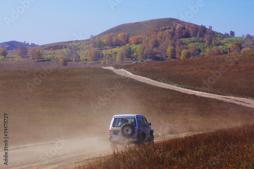 Off-road vehicle running in the grassland