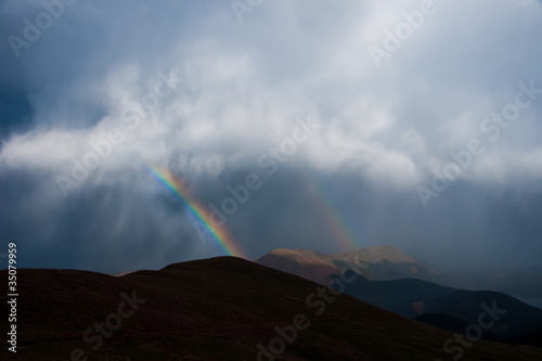 What Noah Must Have Seen - A Rainbow Peeking Through the Clouds Above the Mountaintops
