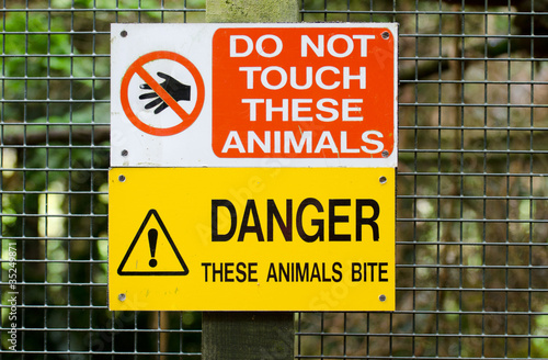 warning sign regarding animlas on fence