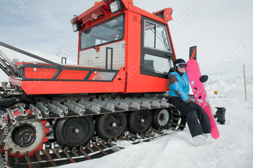 Young snowboarder and ratrak