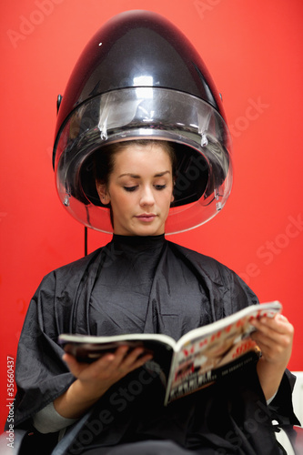 Portrait of a student under a hairdressing machine