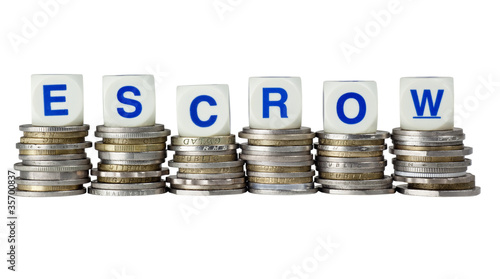 Stacks of coins with the word ESCROW isolated on white