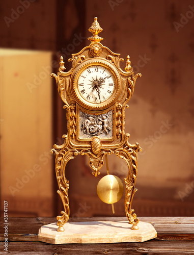 ancient vintage golden brass pendulum clock