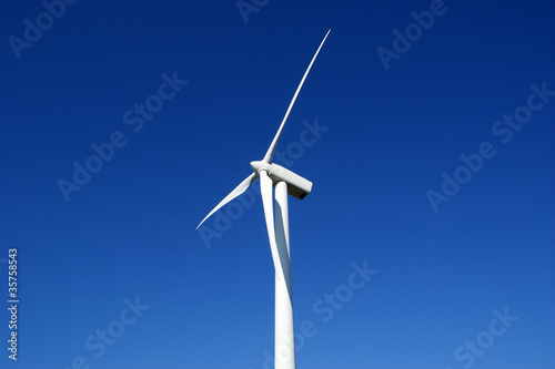 Wind turbine against blue sky