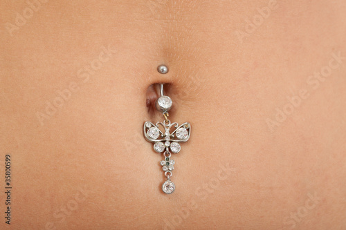 Closeup of a belly button (naval) that is pierced