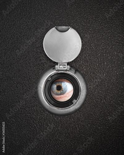 Human eye in peep hole closeup