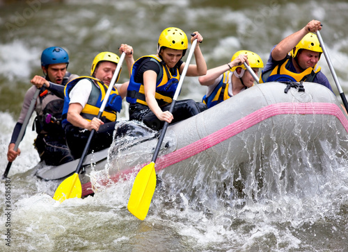 Group of people whitewater rafting