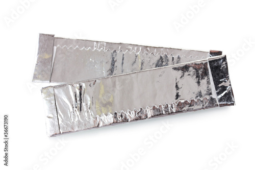 two chewing gums wrapped in standard silver foil, isolated