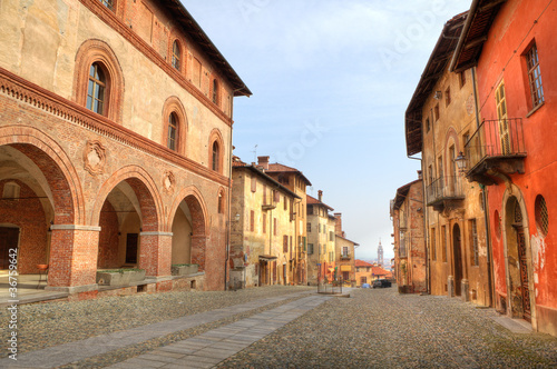 Paved street among historic houses in Saluzzo, Italy.