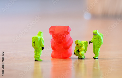 Group of people in protective suit inspecting a jelly bear