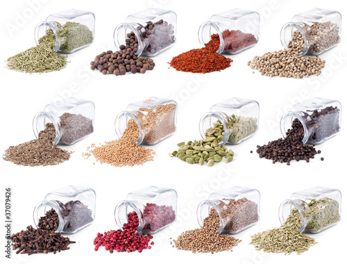 Spices and herbs are scattered on a white background