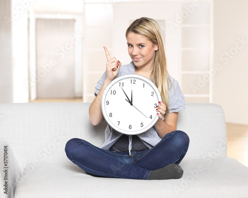 it's 5 before 12 - young woman pointing on clock / time