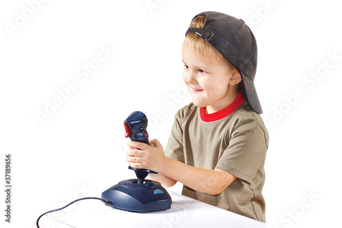 Little boy plays with a joystick on a white background